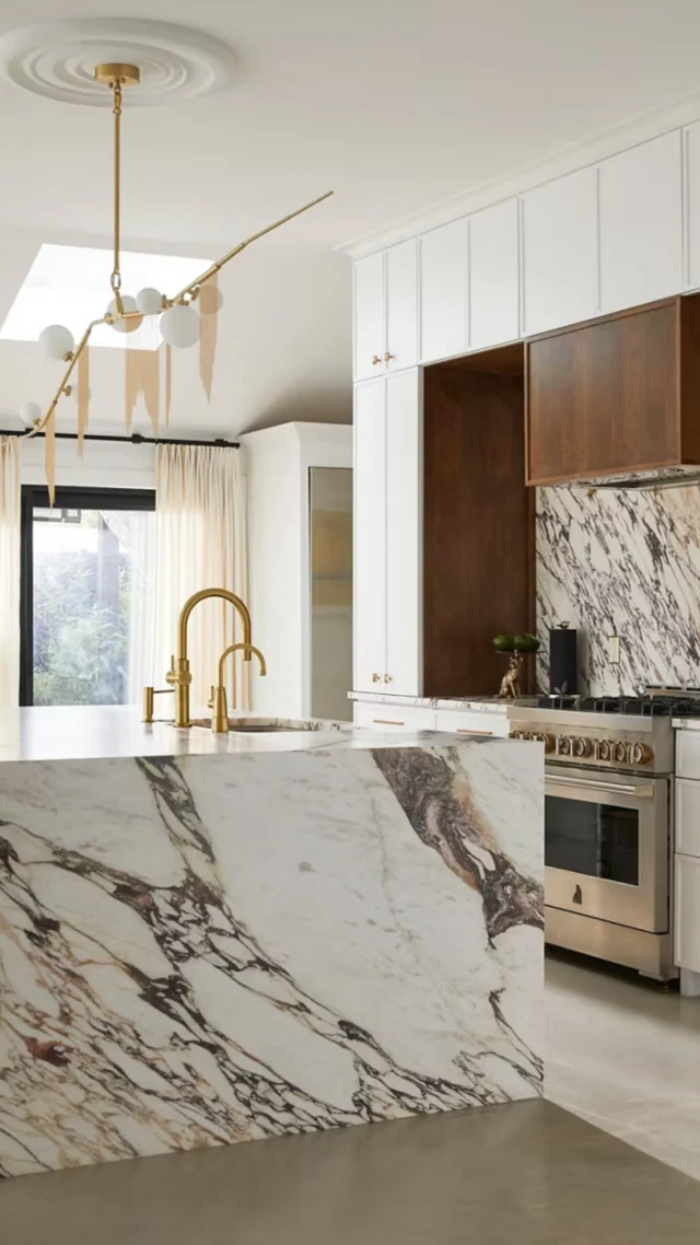 Washing the dishes just got easier and a whole lot more luxurious. 🙌✨Meet the Riverby Kohler workstation sink, where every detail is designed to make kitchen prep more convenient, functional, and beautiful.Featuring the included accessories:✨ Utility rack✨ Left-bowl sink rack✨ ColanderPlus, the hardwood cutting board, an additional accessory that makes this workstation even more versatile.The finishing touches? 🤌🏼Verde Tia Honed Ion Mosaic backsplash by Marble Systems paired with Calacatta Ombré Honed by Crescent Quartz for a perfectly layered, elevated look. Ready to upgrade your kitchen sink? Click the link in our bio to book your showroom appointment.[Triton Stone, Kohler, Kitchen Sinks, Kitchen Sink Design, Work Station Sink]
